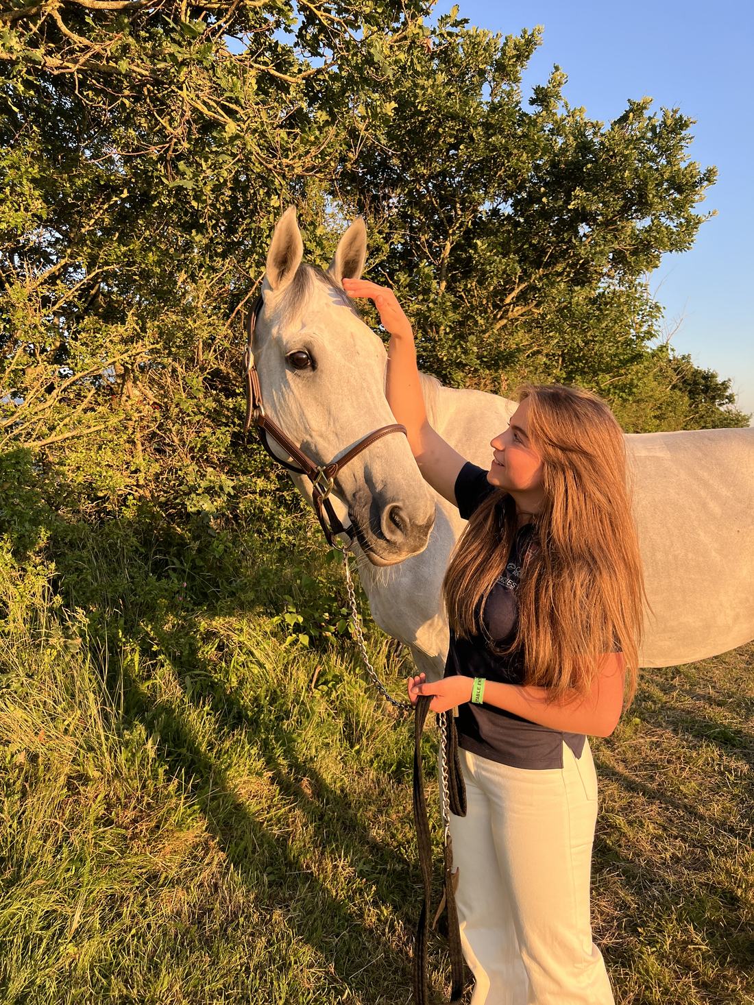 Bertine with her horse in the evening light